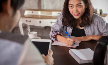 A resume writer gathering notes from her client