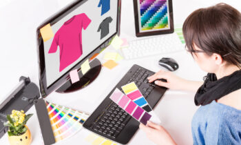 A woman sitting at her computer trying to make money designing t-shirts online