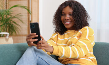 A young woman taking a video survey on her smartphone with Mindswarms