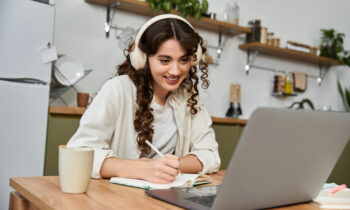 A young woman with curly hair looking for W-2 work from home jobs on her computer