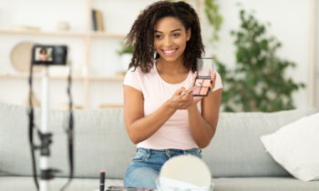 African Beauty Blogger Making Video Reviewing Cosmetics for affiliate marketing without a website article