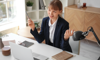 A woman dressed in a suit conducting an informational interview online