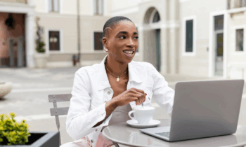 A young female freelancer working at on outdoor cafe on her laptop for blog post work-when-you-want jobs