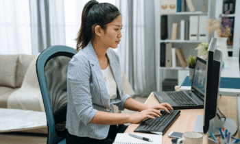 A young female looking for online chat agent jobs on her computer at home