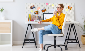 Woman wearing glasses drinking coffee working her virtual assistant job