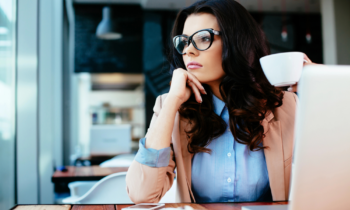A woman in a cafe thinking about her future for blog post finding your career path